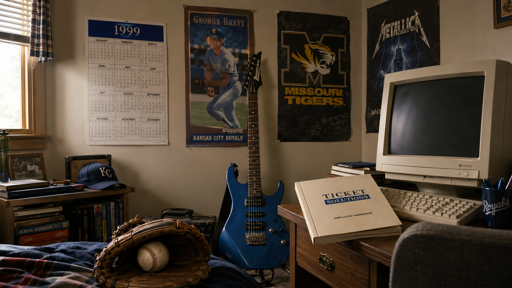 A 1999 bedroom with a CRT computer, blue guitar, baseball glove, George Brett poster, and Ticket Solutions handbook.